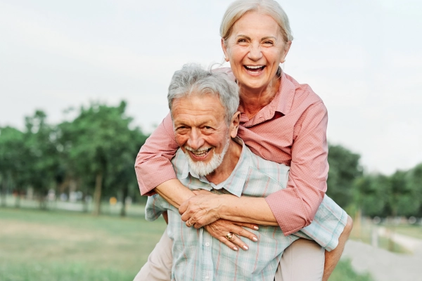 happy older couple with hearing aids
